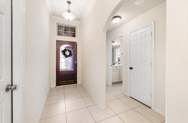 tiled foyer entrance with ornamental molding