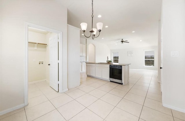 kitchen with white cabinets, ceiling fan with notable chandelier, hanging light fixtures, black dishwasher, and an island with sink