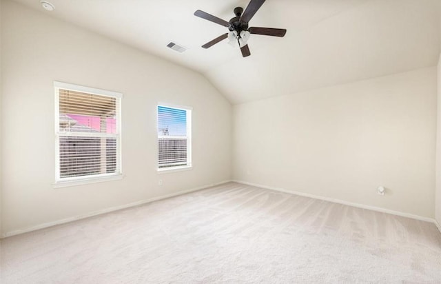 interior space with light carpet, vaulted ceiling, and ceiling fan