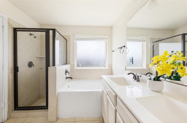 bathroom featuring tile patterned floors, vanity, a healthy amount of sunlight, and plus walk in shower