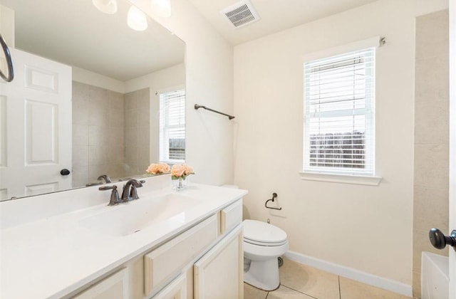 bathroom featuring tile patterned floors, vanity, and toilet