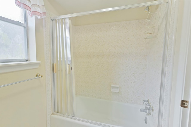 bathroom featuring shower / bath combination with glass door