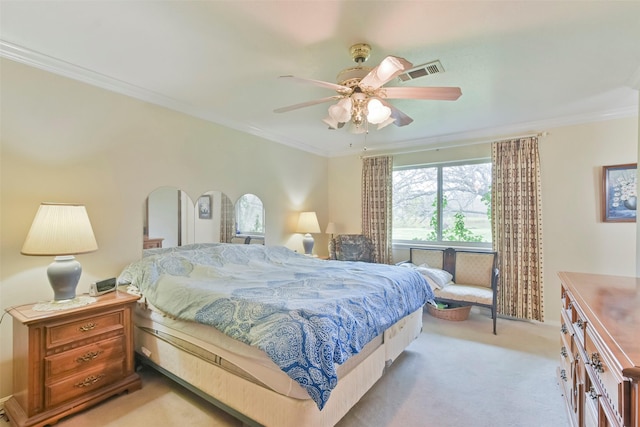 carpeted bedroom with ceiling fan and crown molding