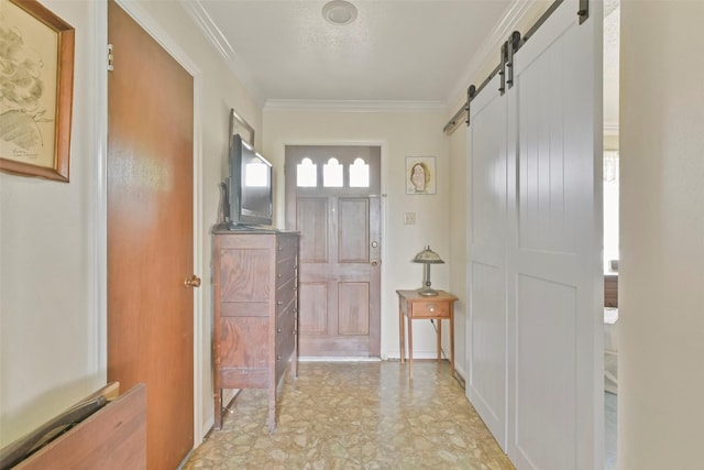 doorway featuring a barn door and ornamental molding