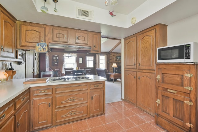 kitchen featuring light tile patterned flooring and white appliances