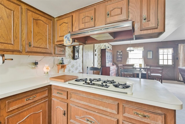 kitchen with white gas stovetop and kitchen peninsula