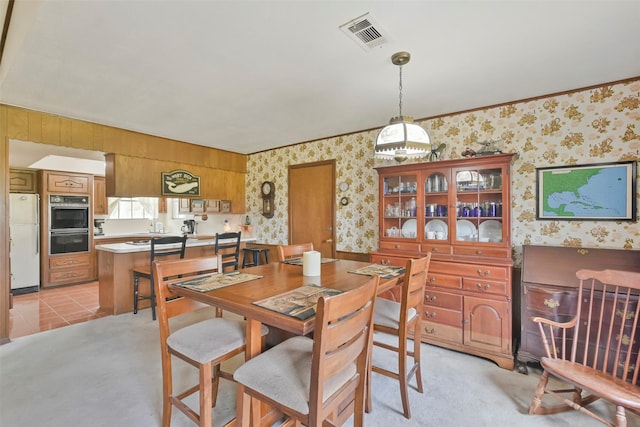 dining room with light carpet