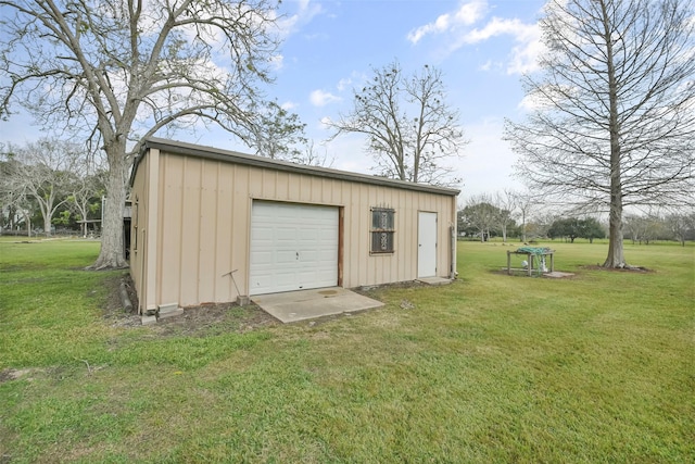 view of outdoor structure with a lawn and a garage