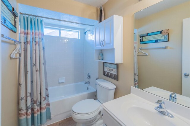 full bathroom featuring shower / bath combination with curtain, vanity, and toilet