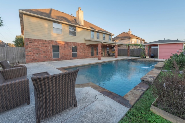 view of pool with a patio and pool water feature