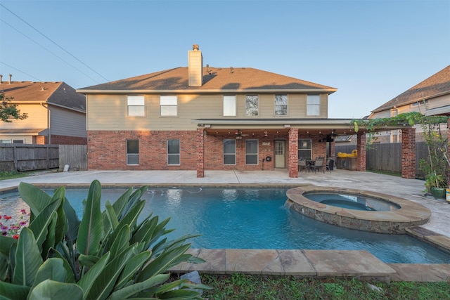 view of swimming pool featuring a patio area and an in ground hot tub