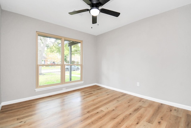 empty room with light hardwood / wood-style flooring and ceiling fan