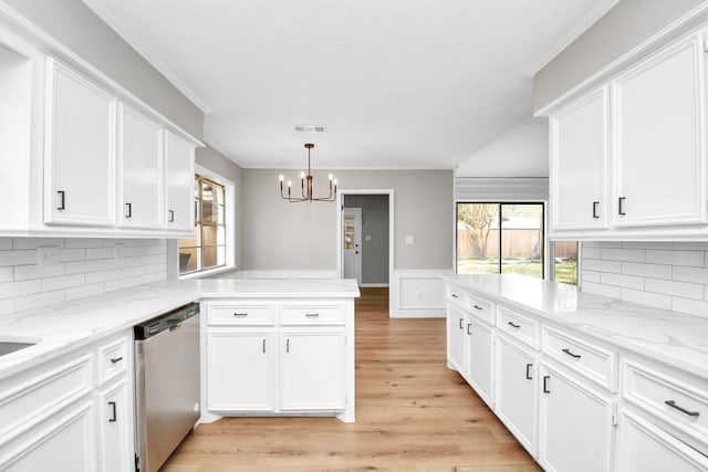 kitchen with dishwasher, an inviting chandelier, white cabinets, hanging light fixtures, and light stone counters