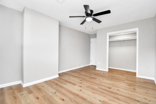 unfurnished bedroom featuring a closet, light hardwood / wood-style floors, and ceiling fan