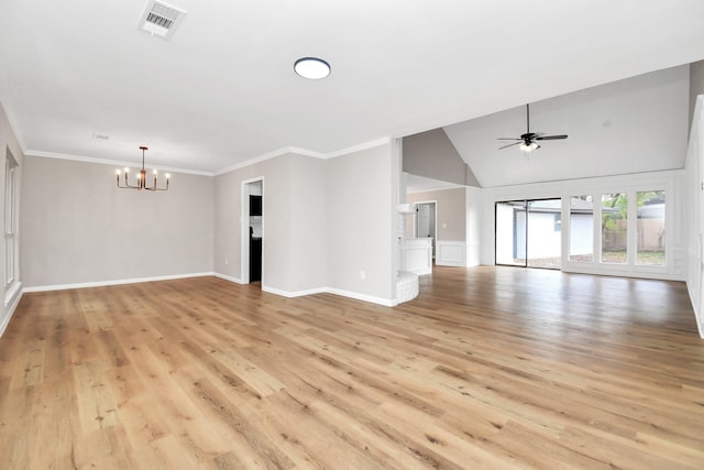 spare room featuring vaulted ceiling, light hardwood / wood-style floors, ceiling fan with notable chandelier, and ornamental molding