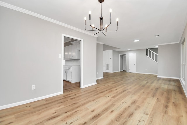 unfurnished dining area with light hardwood / wood-style floors, crown molding, and a notable chandelier