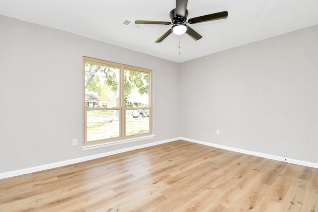 spare room with ceiling fan and light wood-type flooring