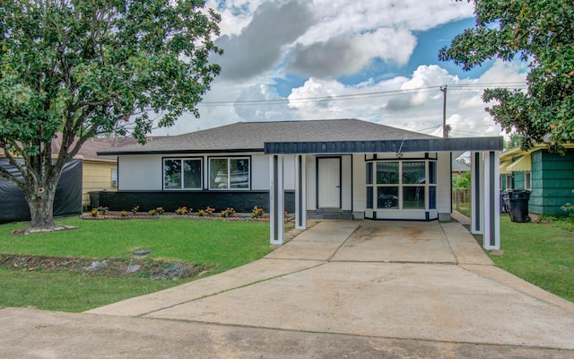 ranch-style home with a front lawn and a carport