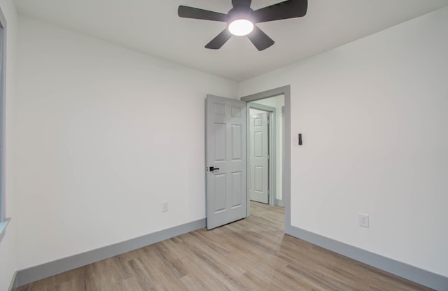 empty room with ceiling fan and light hardwood / wood-style floors