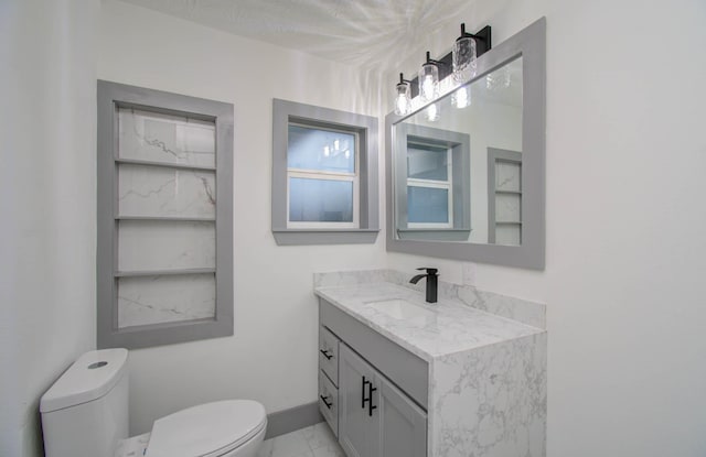 bathroom featuring toilet and vanity