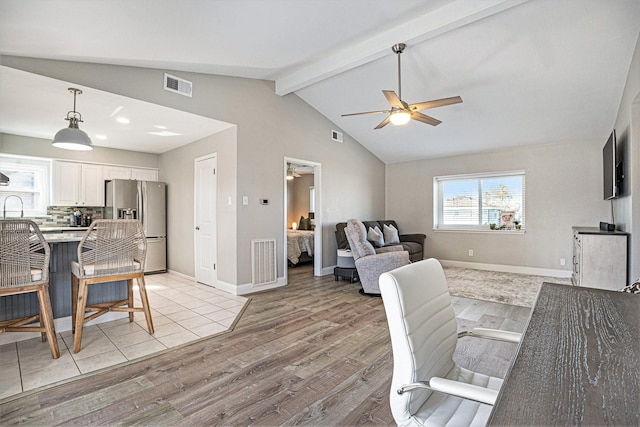 living room with ceiling fan, light hardwood / wood-style flooring, and lofted ceiling with beams