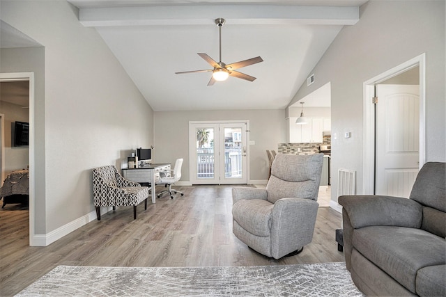 sitting room featuring french doors, vaulted ceiling with beams, light hardwood / wood-style flooring, and ceiling fan