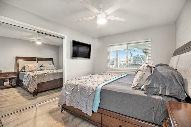 bedroom featuring ceiling fan, a closet, and wood-type flooring