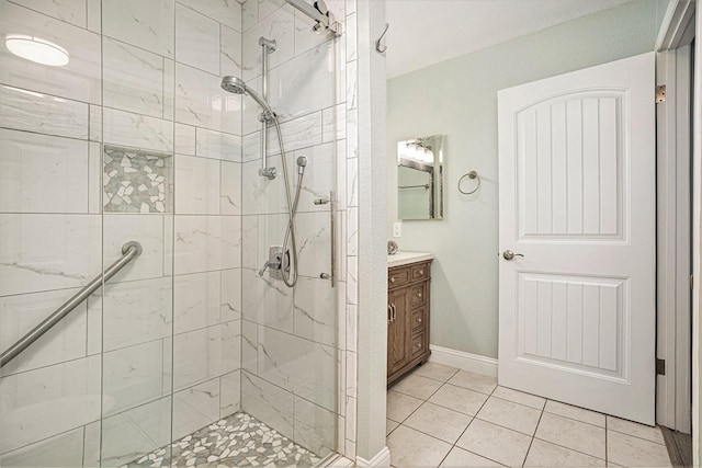 bathroom with tile patterned flooring, vanity, and walk in shower