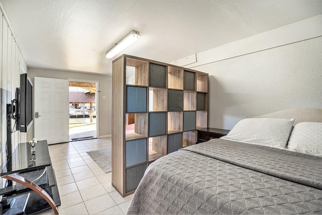 bedroom with light tile patterned floors and a textured ceiling