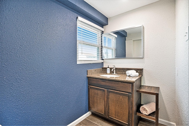 bathroom with vanity and hardwood / wood-style flooring