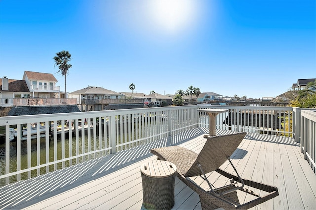 wooden terrace featuring a water view