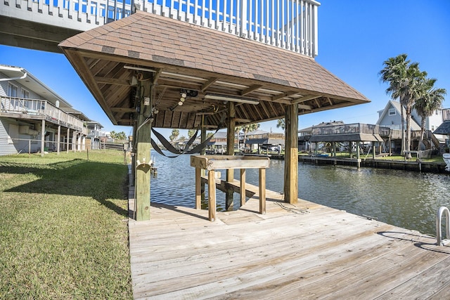 dock area with a yard and a water view