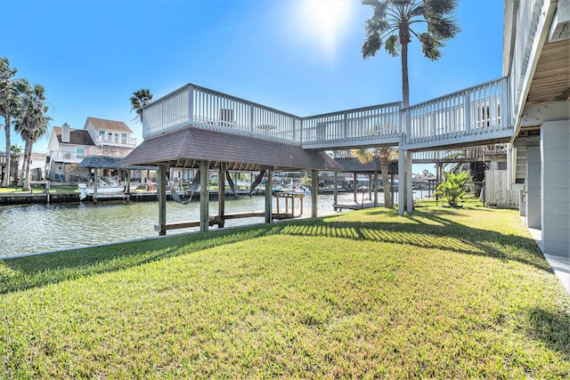 dock area with a water view and a yard