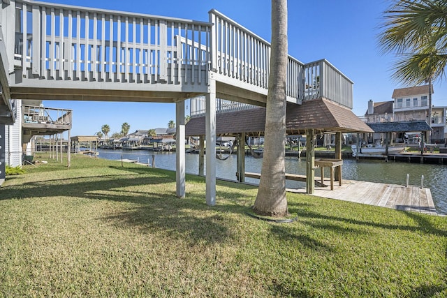 dock area featuring a lawn and a water view