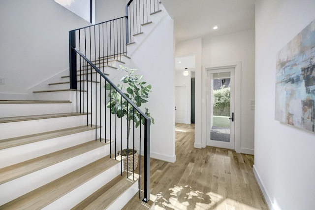 stairway featuring wood-type flooring