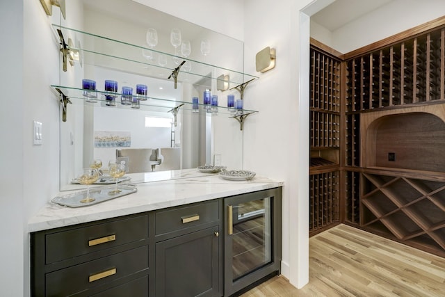 wine area featuring light wood-type flooring and wine cooler