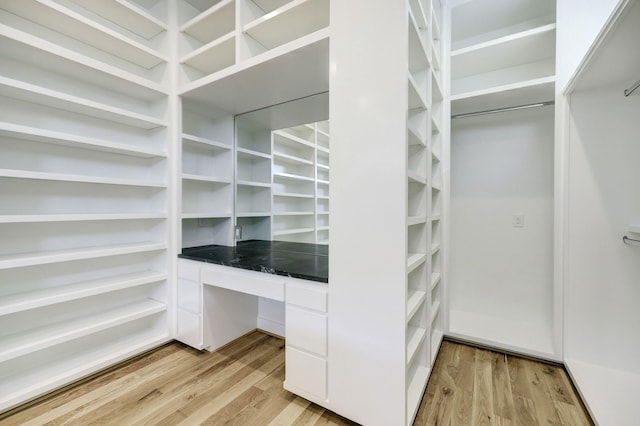 spacious closet featuring light hardwood / wood-style flooring