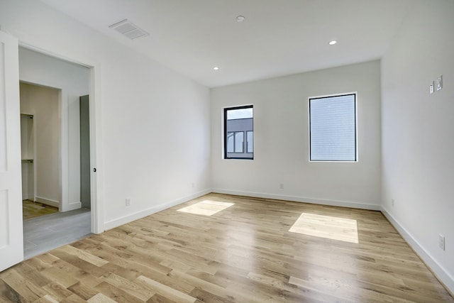 spare room featuring light hardwood / wood-style floors