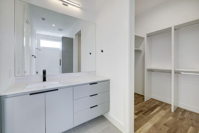 bathroom with hardwood / wood-style floors and vanity