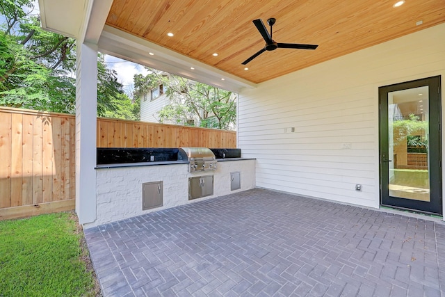 view of patio featuring an outdoor kitchen, ceiling fan, and grilling area