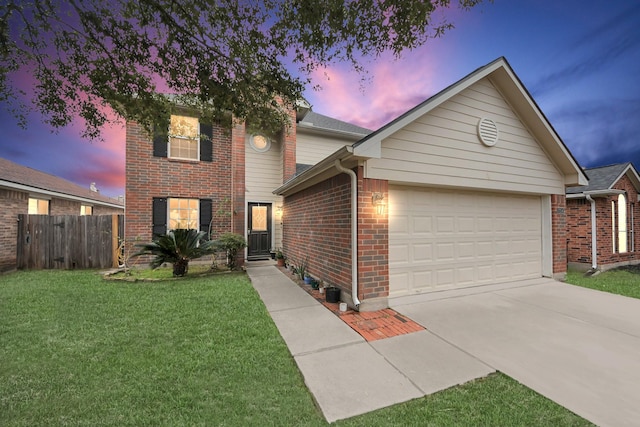 view of front of house with a yard and a garage