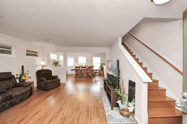 living room featuring hardwood / wood-style floors and a textured ceiling