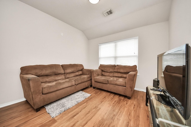 living room with lofted ceiling and light wood-type flooring