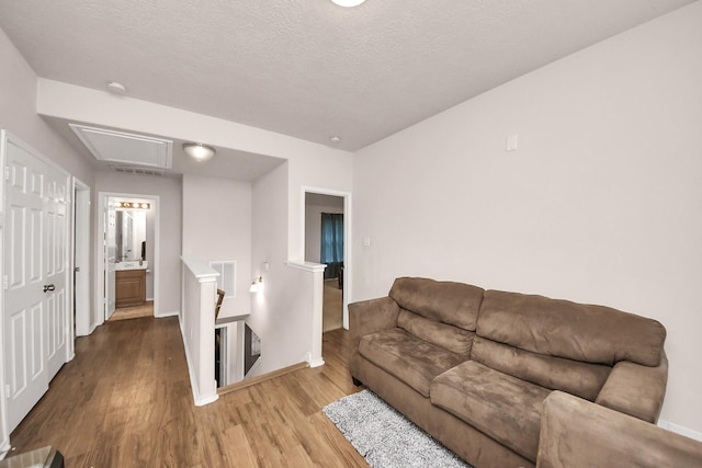 living room featuring light hardwood / wood-style floors and a textured ceiling