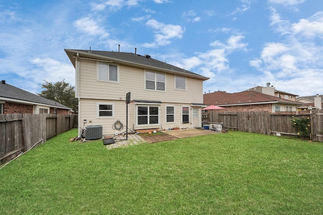 rear view of property with central AC unit, a patio area, and a lawn