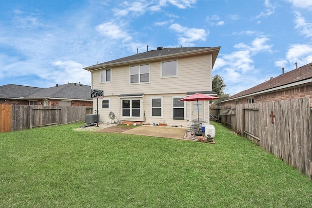 back of property with a patio area, a yard, and cooling unit