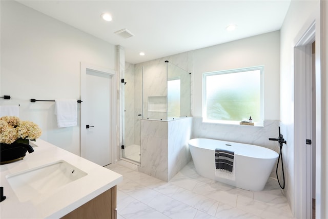 bathroom with vanity, tile walls, and independent shower and bath