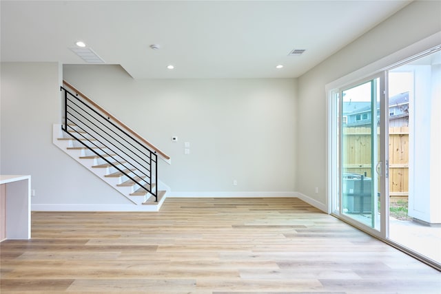 spare room featuring plenty of natural light and light wood-type flooring