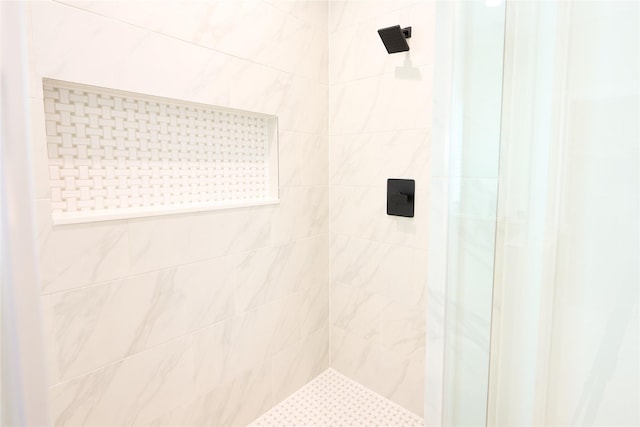 bathroom with tiled shower