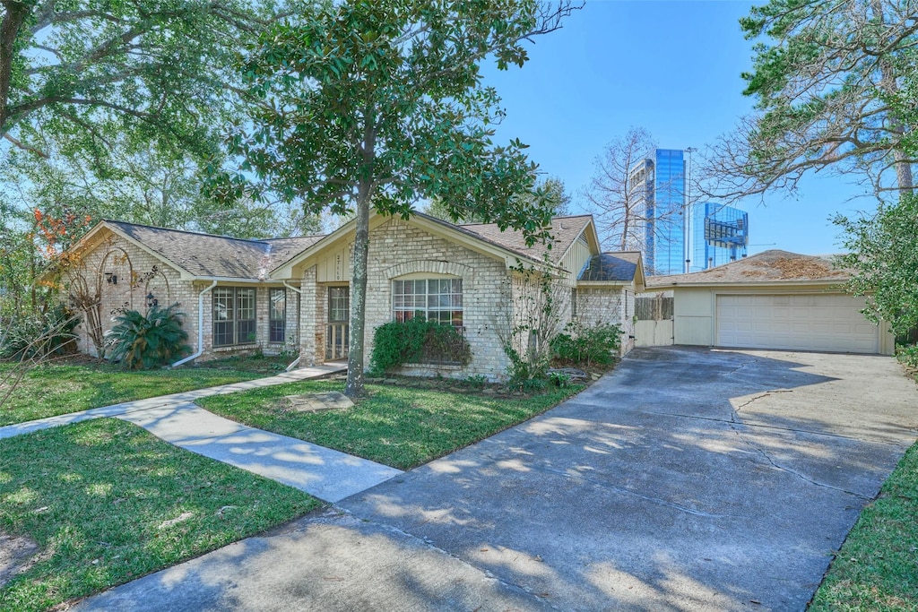 ranch-style home featuring a garage and a front lawn